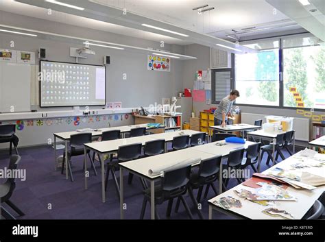 A Teacher Works Alone In A Modern Classroom In A New London Secondary