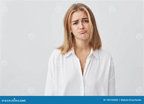 Blonde Caucasian Female Looking Unhappy And Dissatisfied Frowning Her