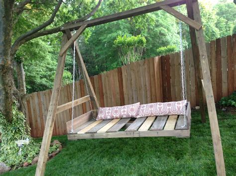 A Wooden Swing Bed Sitting In The Middle Of A Yard