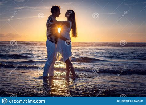 Romantic Couple In Love Kissing On The Beach During Sunset Stock Image