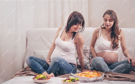 Free Photo Two Pregnant Women Eating Pizza And Salad At Home