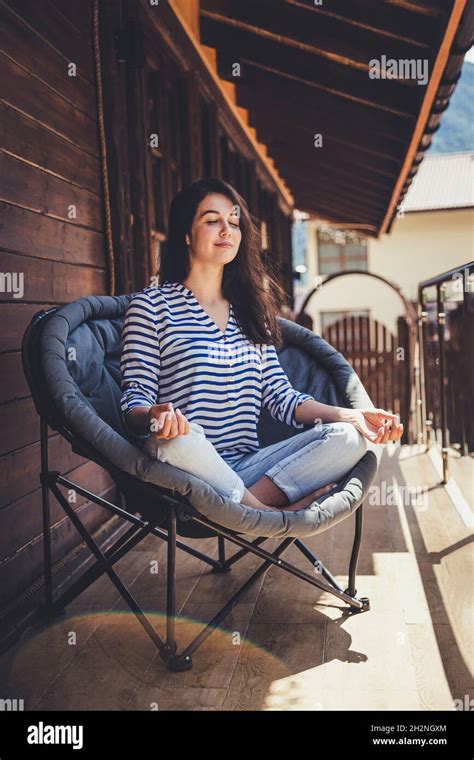 Woman Sitting Cross Legged In Chair High Resolution Stock Photography