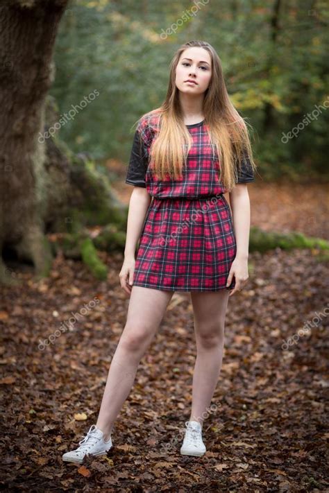 Portrait Of A Beautiful Teenage Girl Standing In A Forest