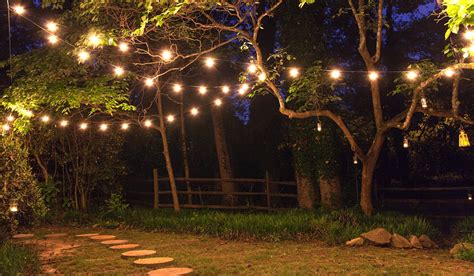 One hanging light bulb glowing different and standing out from unlit incandescent bulbs. Patio String Lights and Bulbs