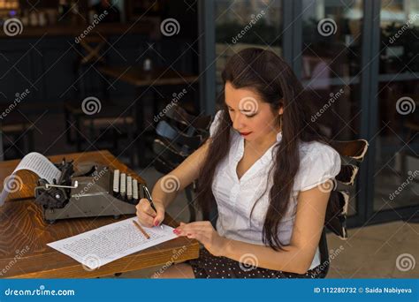 Female Writer With Vintage Typewriter Making Notes In A Coffee S Stock