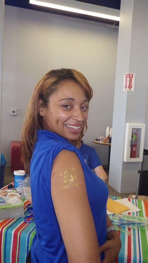 myeshia one of our orthodontic assistants showing off her glitter lach ortho tattoo