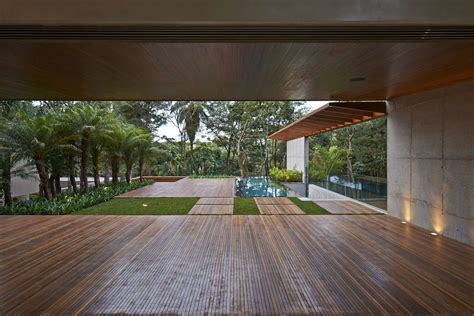 Dig out the patio area about 6 inches deep, fill it with gravel, then top it with a thin layer of coarse sand. Luxurious Home Uses Wood and Stone Elements to Marry ...