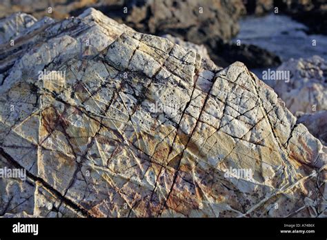 Multi Layered Multi Coloured Rock Criss Crossed By Fracture Lines Near