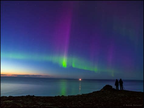 A Couple Enjoy The View Of Aurora Borealis The Northen Lights