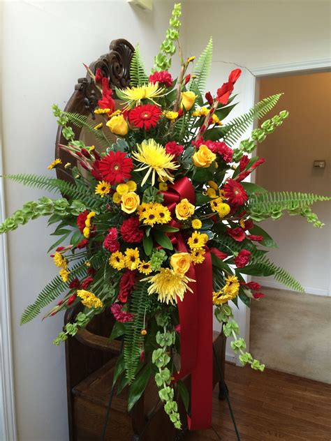 Standing Spray In Yellows And Reds Easter Flowers Funeral Flowers