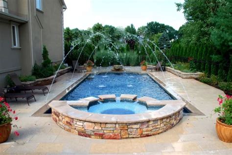 The backyard also features a stacked block paver retaining wall with a large raised area for elevated sitting. Pool Deck Jets: Pros/Cons, Design Ideas & More - Pool Research