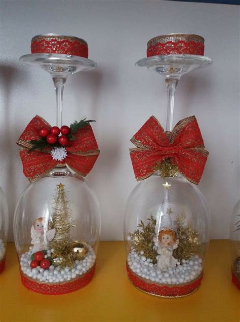 Three Snow Globes With Christmas Decorations In Them On A Table Next To