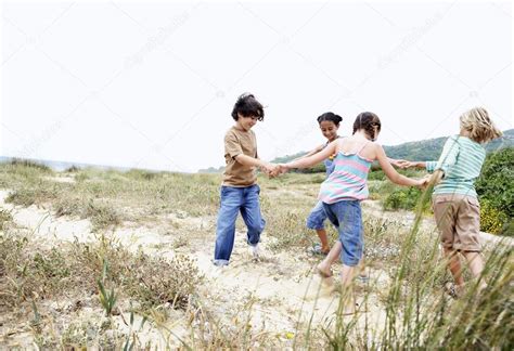 Children Playing Ring Around The Rosy Stock Photo By ©londondeposit