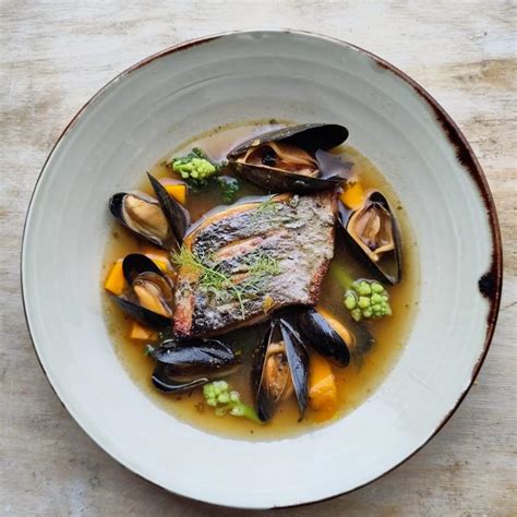 Line Caught Sea Bass With Mussels Seasonal Vegetables And A Spicy Ginger Seaweed Lemon And