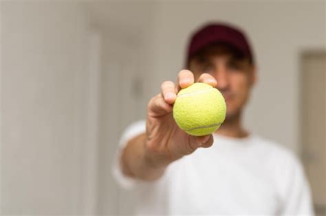 Premium Photo Close Up Of Male Hand Holding Tennis Ball And Racket