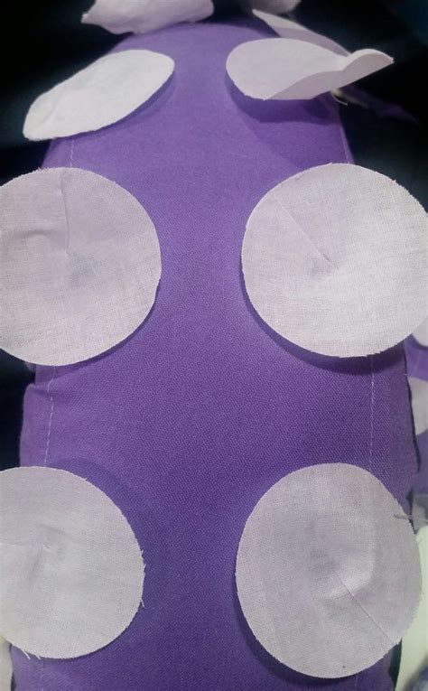 Purple And White Polka Dot Fabric With Circles On The Top In Front Of