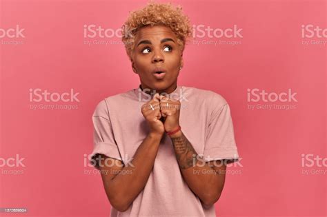 Cute Insecure Curly Darkskinned Woman Looks Away With Clenched Fists