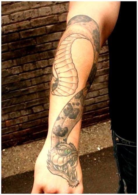 It represents the infinite life cycle from birth to death, just as an animal is prone to eat its own tail. Adorable men's snake tattoo on arm and shoulder