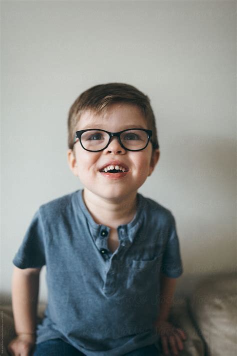 Portrait Of Playful Young Boy Inside Wearing Cool Glasses By Stocksy