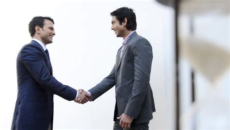 Shot Of Two Businessmen Shaking Their Hands And Talking Stock Footage