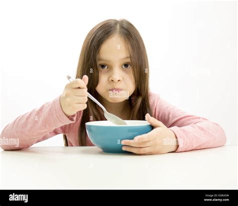 Young Girl Eating Cereal From Bowl For Her Breakfast Stock Photo Alamy