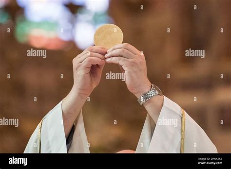 Priest Giving Eucharist Stock Photo Alamy