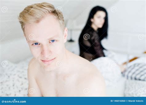 Young Couple Having Problems In Bed During Intimate Moments In Bedroom