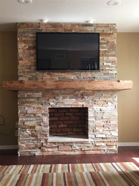 Modular shelving units by black market. Stone fireplace with wrap around barn beam mantel | Brick ...
