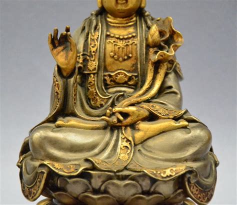 Gold meditative kwan yin gold statue of kwan yin in the traditional meditation position sitting atop a lotus blossom centered in the sacred flame. Chinese Ming Dynasty bronze Gold gilt Kwan-Yin statue