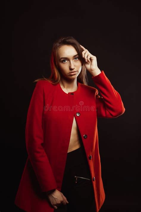 Stylish Young Woman In Trendy Red Coat Clothed On The Naked Body Stock
