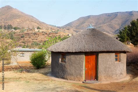 Traditional African Round Clay House With Thatched Roof In Village