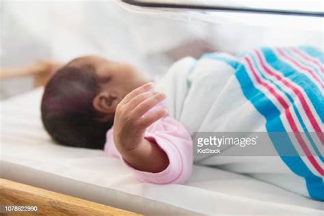 African American Baby Sleeping In Crib Photos And Premium High Res