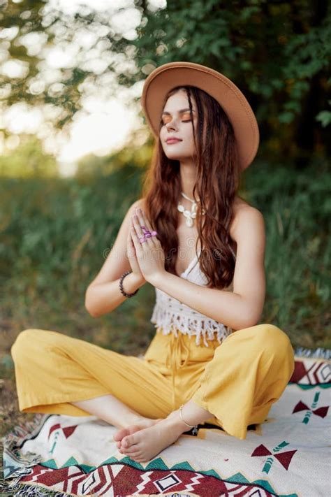 Woman In Ecological Clothing In A Hippie Look Sits On A Colored Plaid
