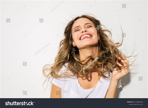 Young Woman Blowing Hair Smiling Joy Stock Photo 1234066576 Shutterstock