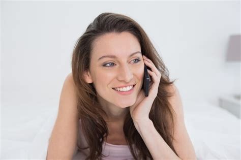 Premium Photo Close Up Of Smiling Woman Using Mobile Phone In Bed