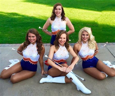 Four Beautiful Women In Cheerleader Outfits Posing For A Photo With