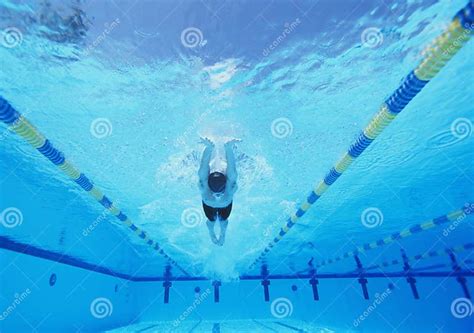 Underwater Shot Of Young Male Athlete Swimming In Pool Stock Photo