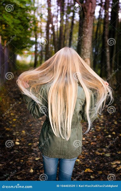 Girl From Behind Outside Waiving Her Long Blonde Hair Stock Image