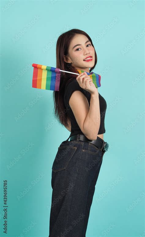 lgbtq girl and pride flag sexy lesbian girl and lgbtq flag standing blue green background