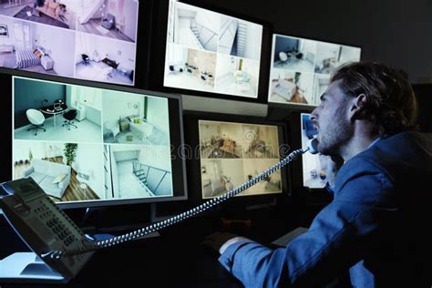 Security Guard Monitoring Modern Cctv Cameras In Surveillance Room