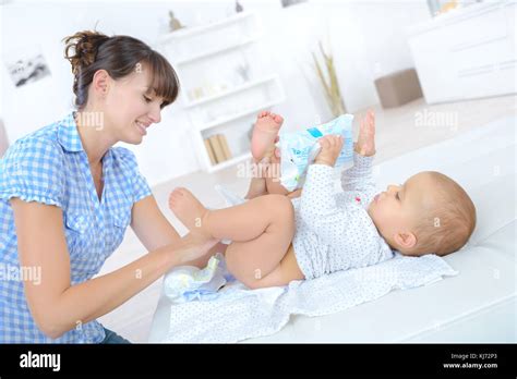 Mother Changing Diapers Of A Nine Months Old Baby Stock Photo Alamy