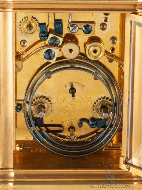 An Antique Clock With Gears And Dials On Its Face Showing The Time