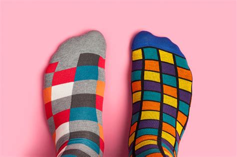 Feet and feet are the same measurement. Foot In Different Colorful Socks On Pink Background Stock ...