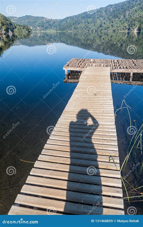 Wooden Pier And Photographer`s Silhouette At Lago Tilquilco Lake In