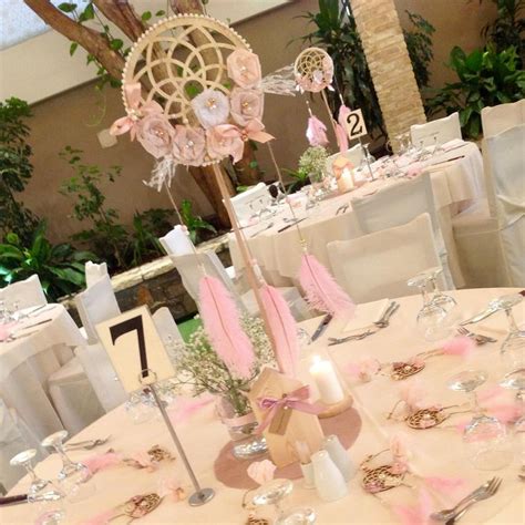 the tables are decorated with pink and white decorations