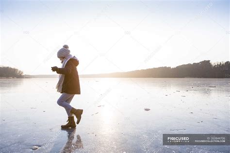 Germany Brandenburg Lake Straussee Girl Walking On Frozen Lake