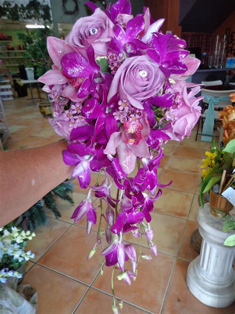 cascading bridal bouquet of lavender roses mauve cymbidium orchids and purple dendrobium