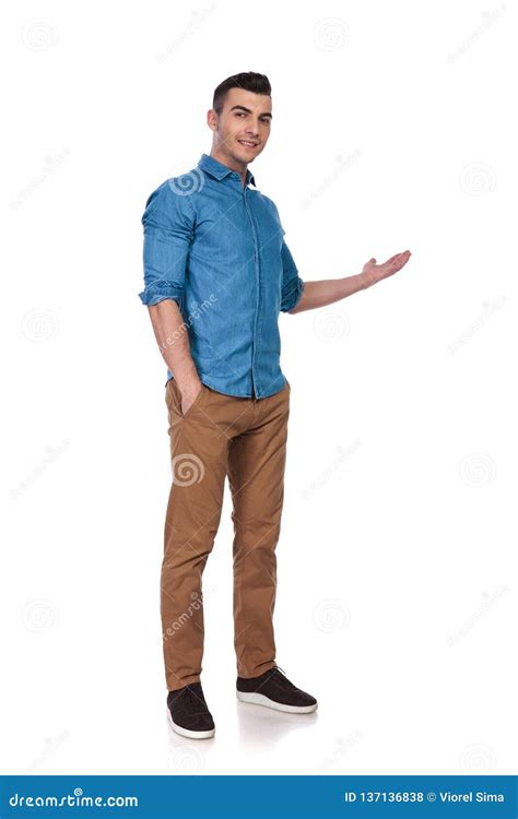 Relaxed Casual Man Standing And Presenting To Side Stock Photo Image