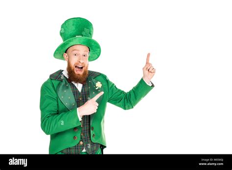 Excited Handsome Leprechaun In Green Suit And Hat Presenting Something Isolated On White Stock