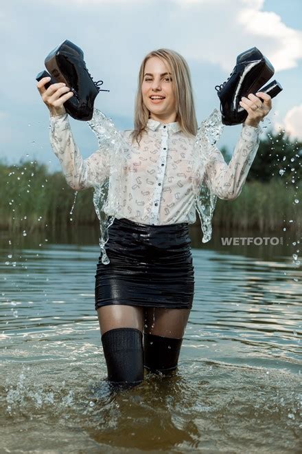 Swimming By Soaking Wet Blonde Girl In Sexy Tights Mini Skirt And Shoes With High Heels